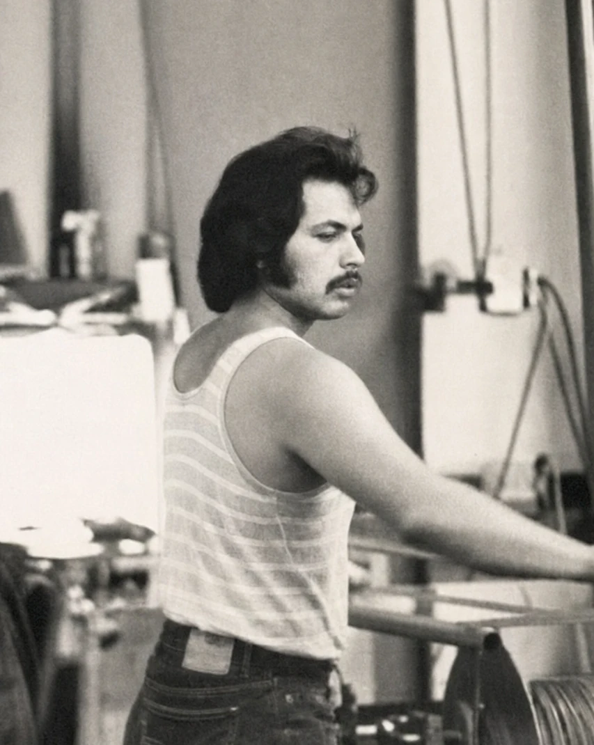 Harry Garewal operating manufacturing equipment in 1973, with his full head and upper body visible